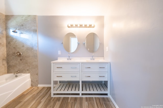 bathroom featuring a tub to relax in, hardwood / wood-style flooring, and vanity