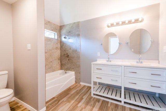 full bathroom featuring vanity, toilet, tiled shower / bath combo, and hardwood / wood-style floors