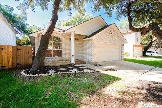 single story home featuring a garage, concrete driveway, brick siding, and fence