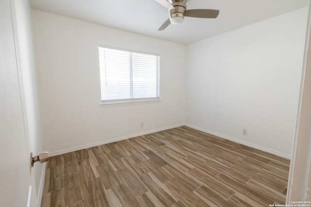 spare room with ceiling fan and hardwood / wood-style flooring