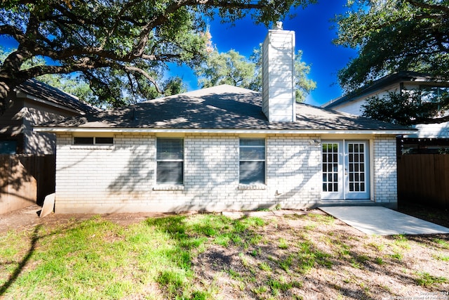 rear view of property with a patio area and a lawn