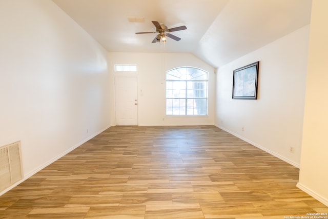 unfurnished room featuring lofted ceiling, ceiling fan, and light hardwood / wood-style floors