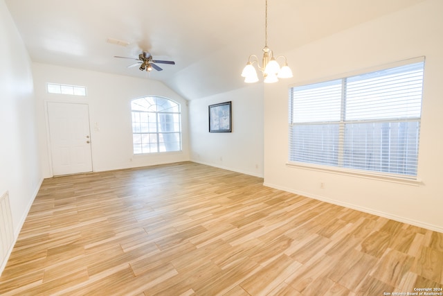 interior space with lofted ceiling, light hardwood / wood-style flooring, and ceiling fan with notable chandelier