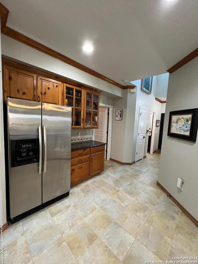 kitchen with stainless steel fridge with ice dispenser and crown molding