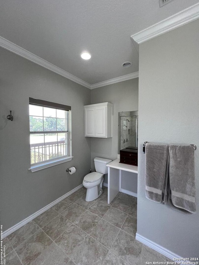 bathroom with toilet and crown molding