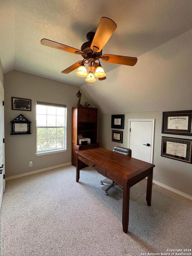 carpeted office space featuring ceiling fan, a textured ceiling, and vaulted ceiling