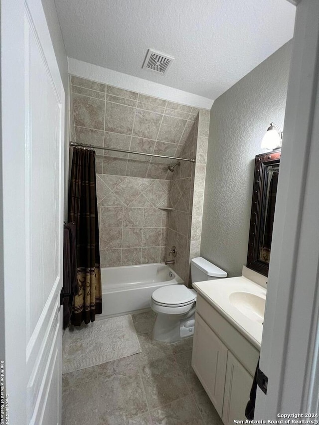 full bathroom with tile patterned floors, toilet, a textured ceiling, vanity, and shower / bathtub combination with curtain