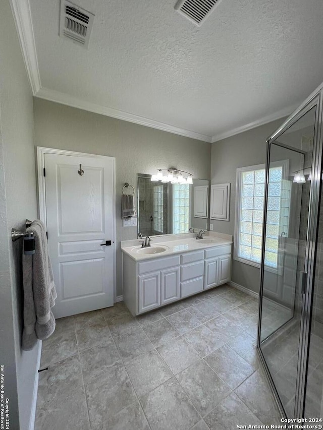 bathroom with an enclosed shower, vanity, a textured ceiling, and crown molding