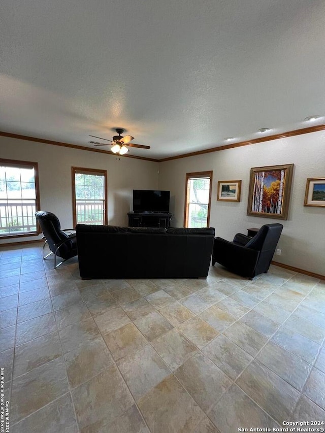 unfurnished living room featuring crown molding, ceiling fan, and plenty of natural light