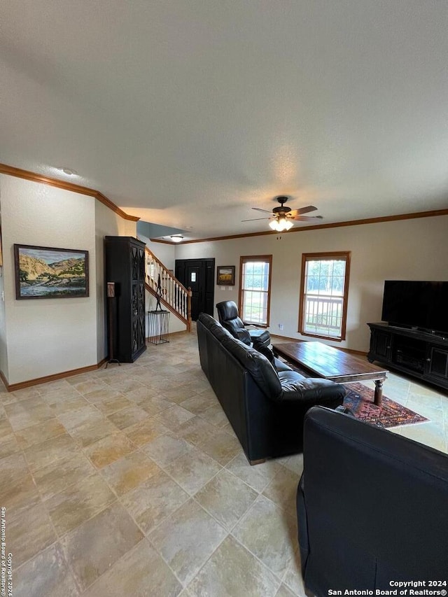 living room with ornamental molding, a textured ceiling, and ceiling fan