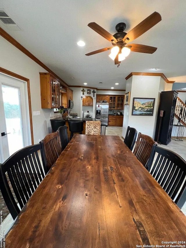 dining area featuring light hardwood / wood-style floors, ceiling fan, and crown molding