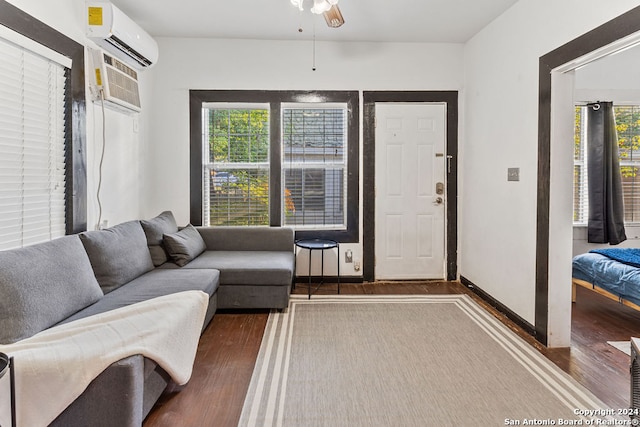 living room with ceiling fan, dark hardwood / wood-style flooring, and a healthy amount of sunlight