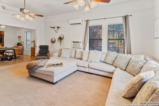 living room with a wall mounted AC, ceiling fan, and carpet flooring