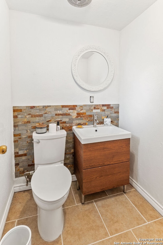 bathroom featuring vanity, toilet, and tile patterned flooring