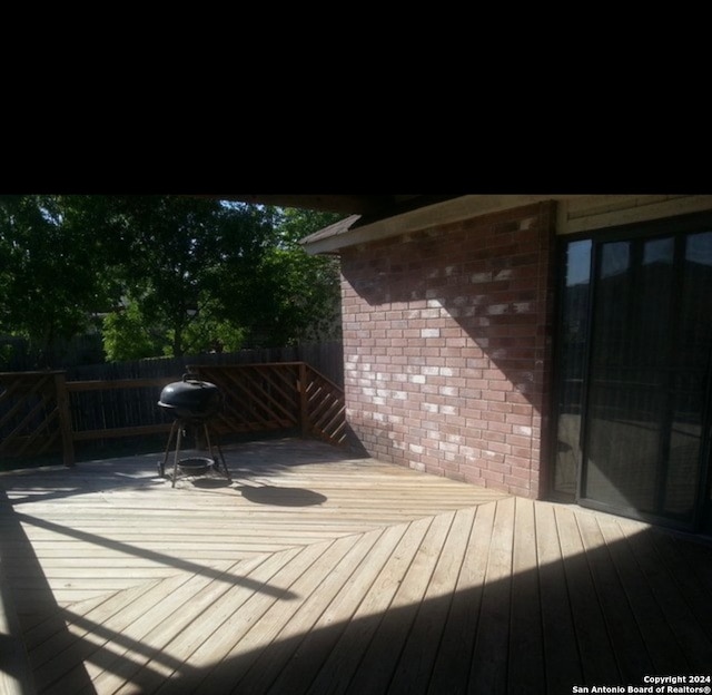 wooden deck featuring area for grilling