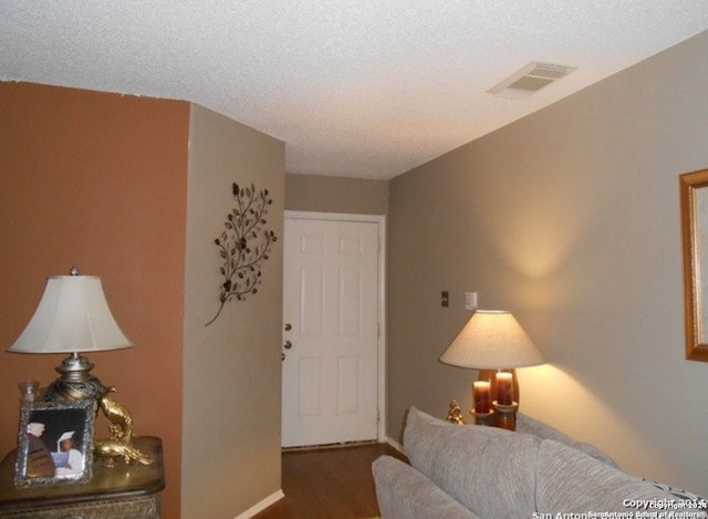 bedroom featuring a textured ceiling and hardwood / wood-style floors