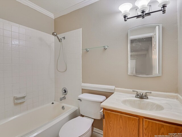 full bathroom featuring crown molding, vanity, toilet, and tiled shower / bath combo