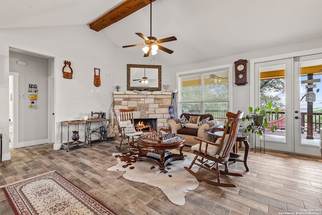 interior space with a fireplace, french doors, beamed ceiling, wood-type flooring, and ceiling fan