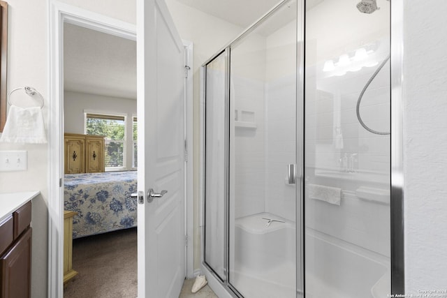 ensuite bathroom with a stall shower, vanity, and ensuite bathroom