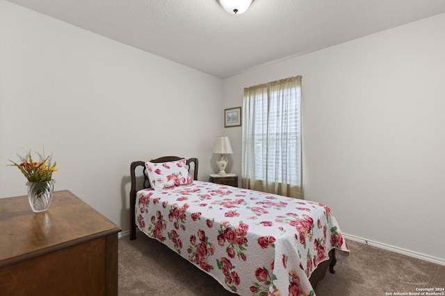 carpeted bedroom featuring baseboards