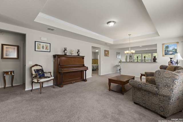 carpeted living room featuring baseboards, visible vents, ornamental molding, a tray ceiling, and a notable chandelier