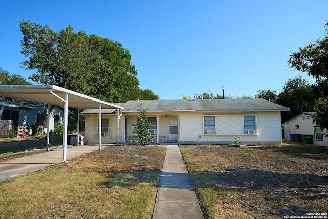 ranch-style home with a front lawn and a carport