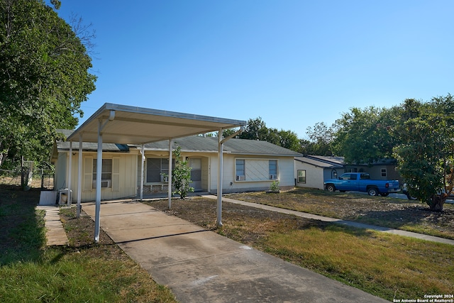 view of front of house with a front lawn and a carport