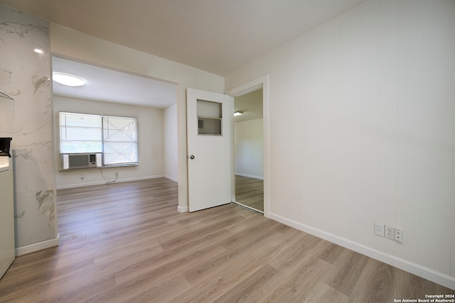 interior space with cooling unit and light hardwood / wood-style floors