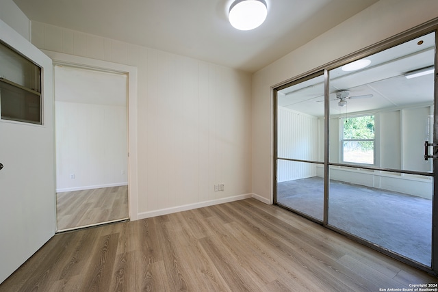 unfurnished bedroom with a closet and light wood-type flooring