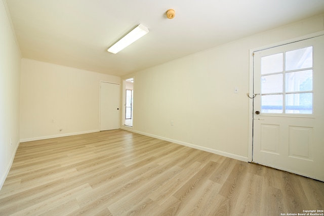 unfurnished room featuring a healthy amount of sunlight and light hardwood / wood-style floors