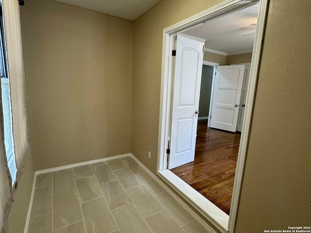 unfurnished room with crown molding and light hardwood / wood-style floors