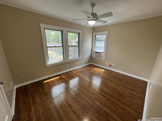 empty room featuring dark wood-type flooring, ceiling fan, cooling unit, and crown molding