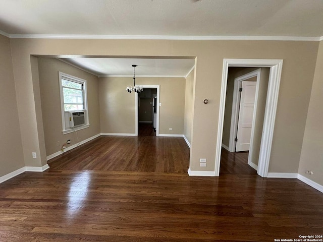 spare room with ornamental molding, dark wood-type flooring, and a notable chandelier