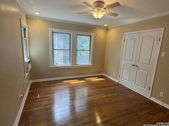 unfurnished bedroom with baseboards, wood finished floors, a ceiling fan, and crown molding