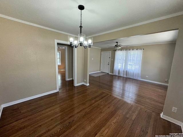 unfurnished dining area featuring ceiling fan with notable chandelier, dark hardwood / wood-style flooring, and crown molding