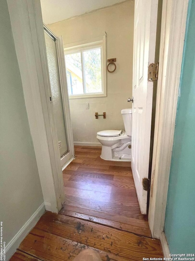 bathroom with toilet and hardwood / wood-style flooring