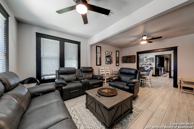 living room with ceiling fan and light hardwood / wood-style floors