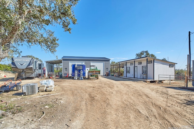 exterior space featuring an outdoor structure, a garage, and central AC unit