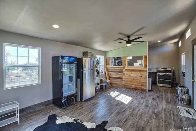living room with lofted ceiling, ceiling fan, and dark hardwood / wood-style flooring