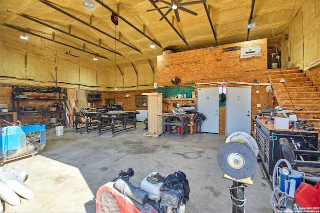 garage with a workshop area and ceiling fan
