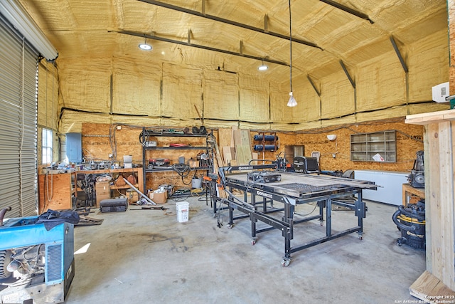 garage featuring electric panel and a workshop area