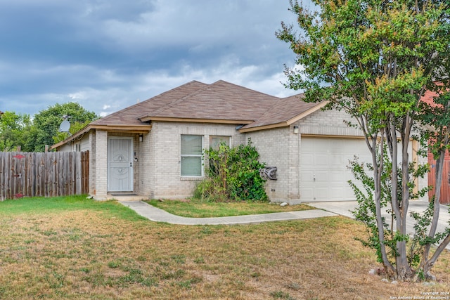 ranch-style house featuring a garage and a front lawn