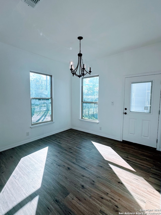 interior space featuring dark wood-type flooring and a chandelier