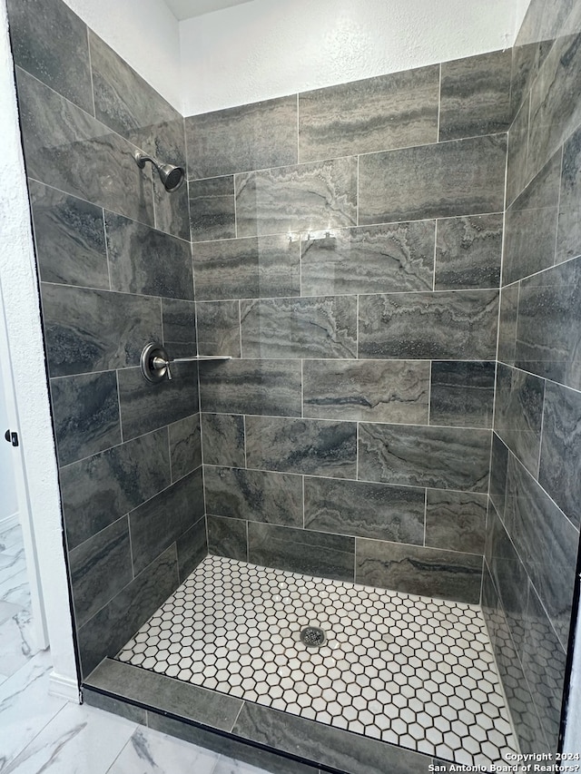 bathroom with tiled shower