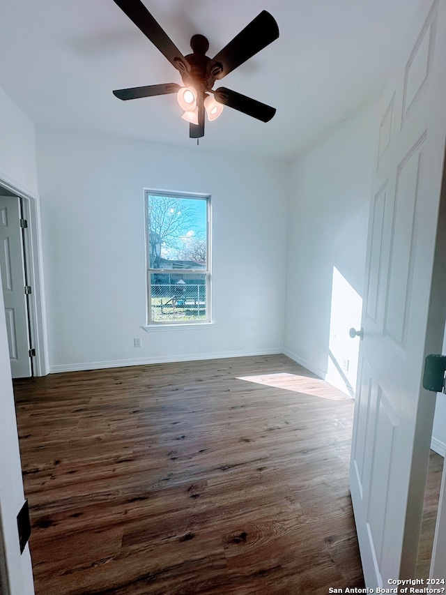 spare room featuring ceiling fan and dark hardwood / wood-style floors