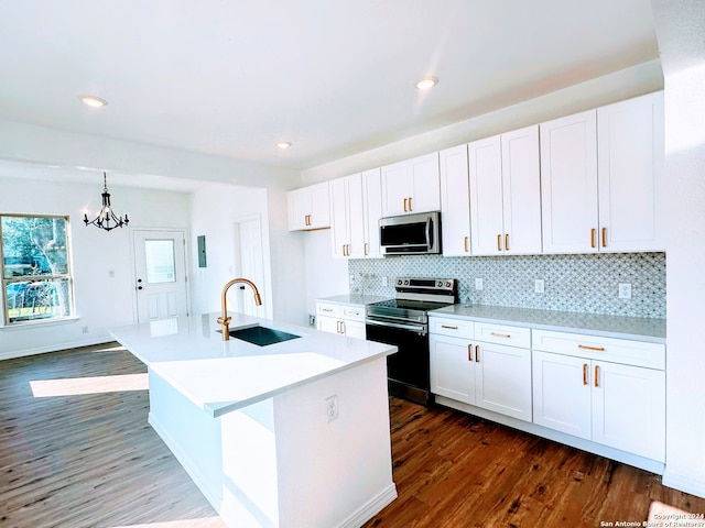 kitchen featuring dark hardwood / wood-style flooring, a center island with sink, stainless steel appliances, sink, and white cabinets