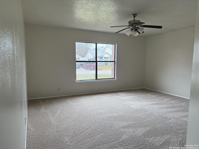 unfurnished room featuring carpet floors, a textured ceiling, and baseboards