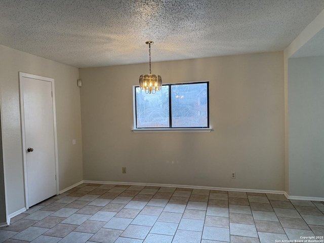 unfurnished room with light tile patterned floors, a textured ceiling, baseboards, and a notable chandelier