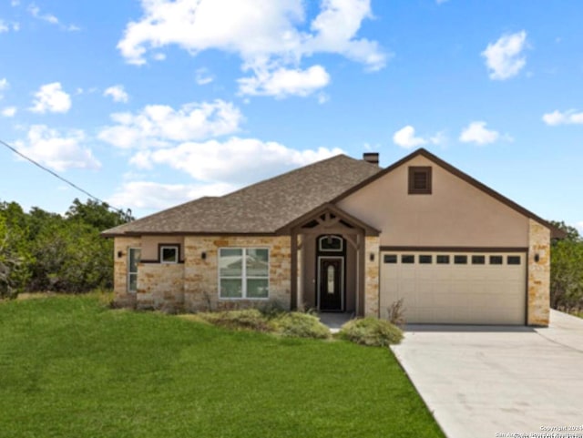 view of front facade with a front lawn and a garage