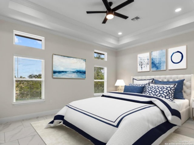 bedroom with ceiling fan, ornamental molding, and a tray ceiling